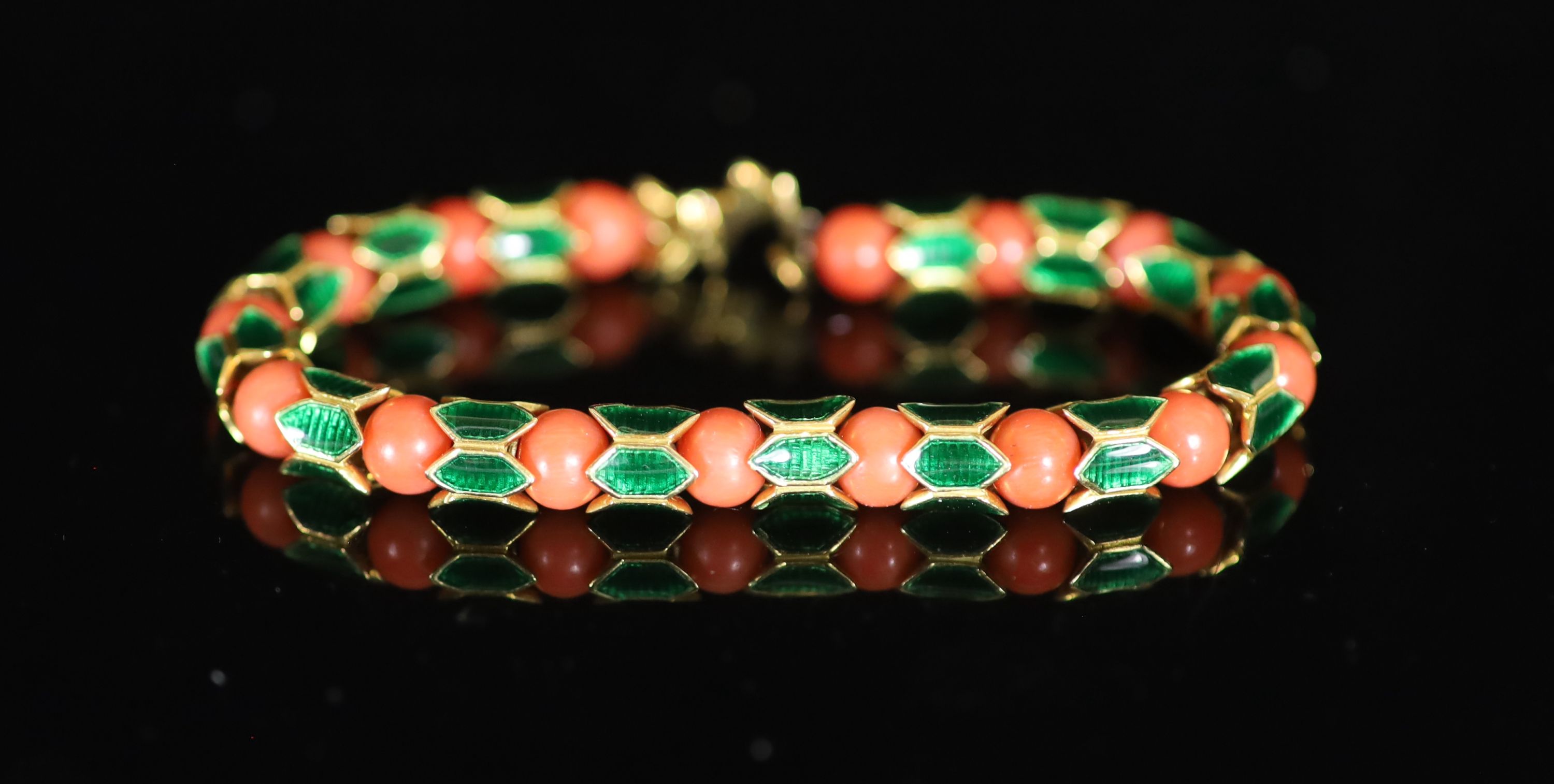 A good 1950's Cartier gold, coral bead and green enamel set articulated bracelet